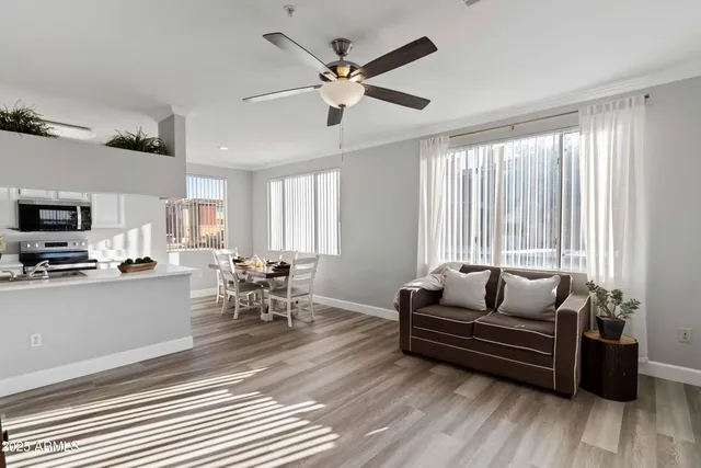a living room with furniture and kitchen view
