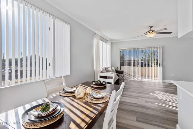 a dining room with furniture a rug and wooden floor