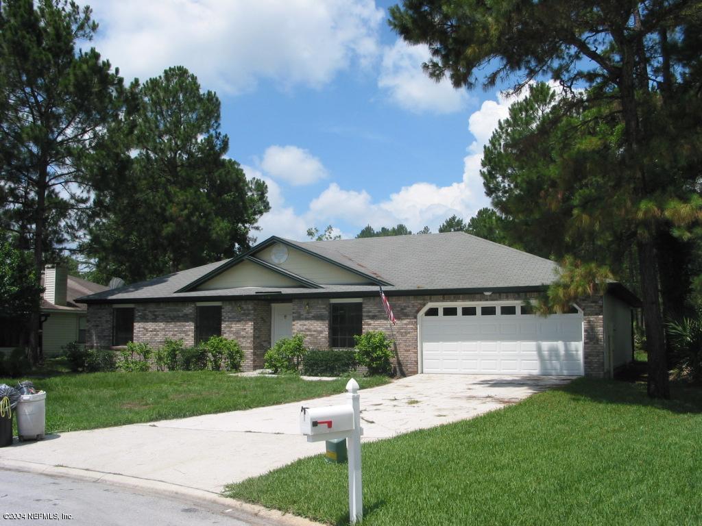 1670 Rusty Rail Road Jacksonville, FL 32225 - Photo 1 of 3 a patio with a table and chairs under an umbrella