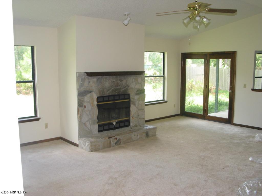 1670 Rusty Rail Road Jacksonville, FL 32225 - Photo 2 of 3 an empty room with windows and fireplace