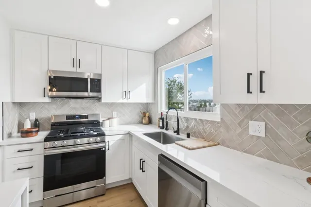 a kitchen with a sink stove and microwave