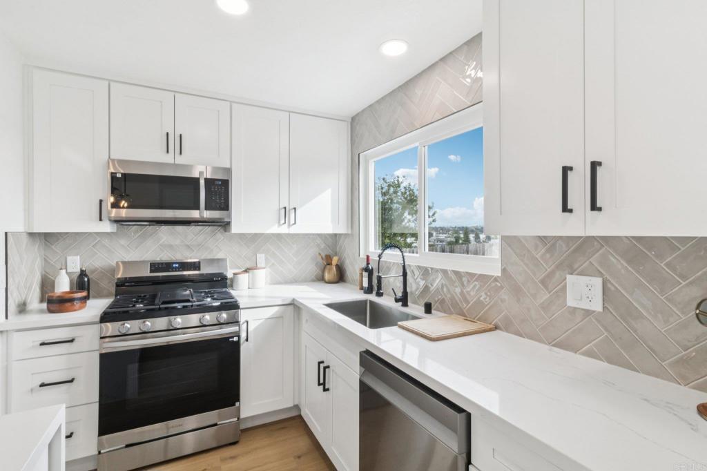 4723 Rim Rock Road Oceanside, CA 92056 - Photo 11 of 29 a kitchen with a sink stove and microwave