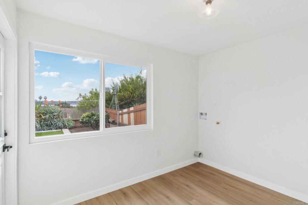 4723 Rim Rock Road Oceanside, CA 92056 - Photo 13 of 29 an empty room with wooden floor and windows
