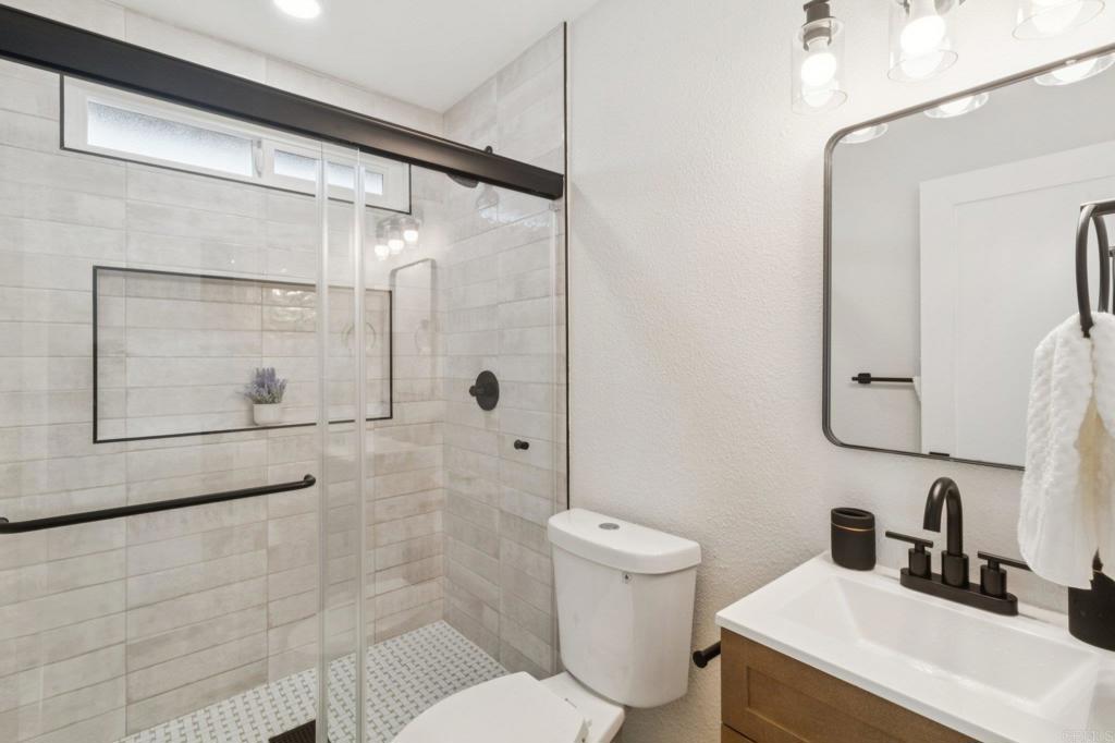 4723 Rim Rock Road Oceanside, CA 92056 - Photo 19 of 29 a bathroom with a sink toilet and shower