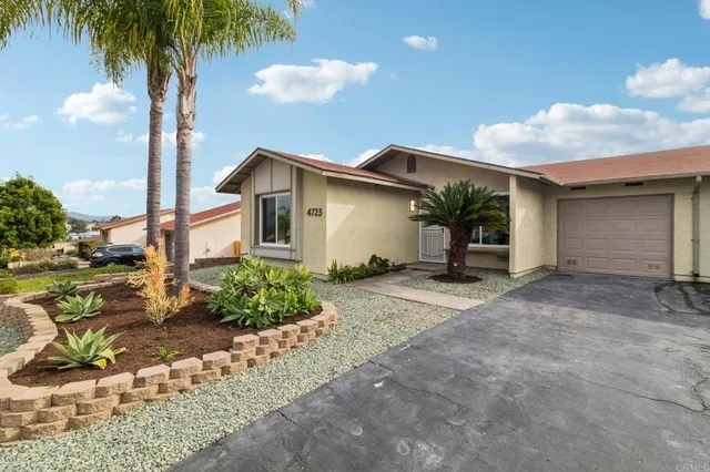a view of a house with a yard and garage