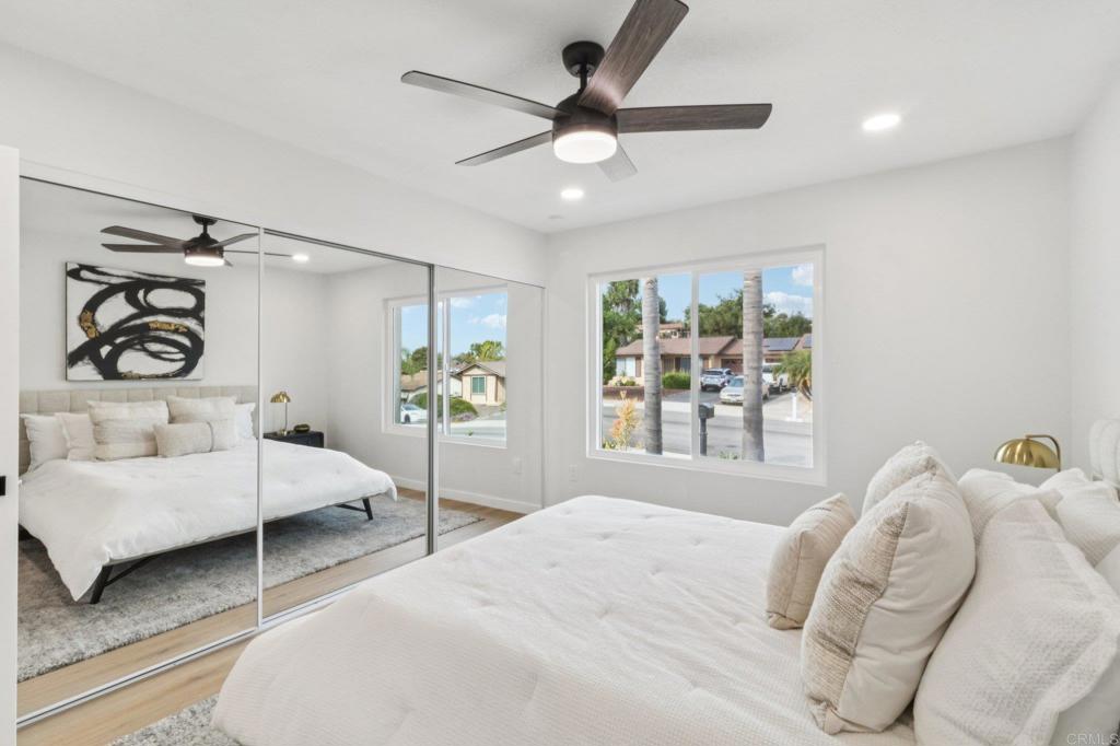 4723 Rim Rock Road Oceanside, CA 92056 - Photo 21 of 29 a bedroom with a bed window and a walk in closet