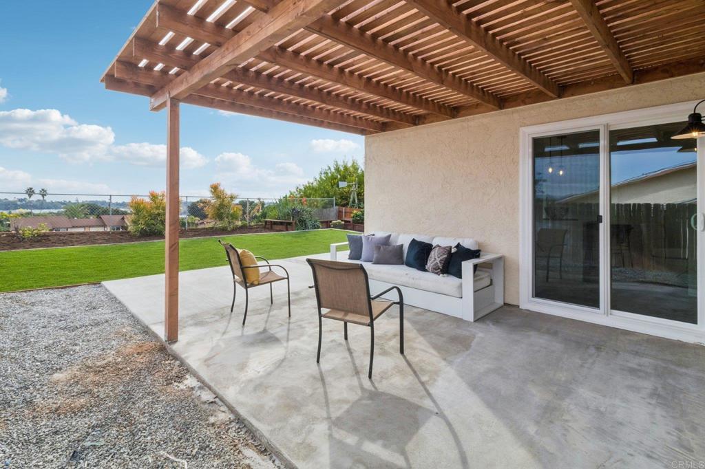 4723 Rim Rock Road Oceanside, CA 92056 - Photo 25 of 29 a view of a patio with a table chairs and a backyard