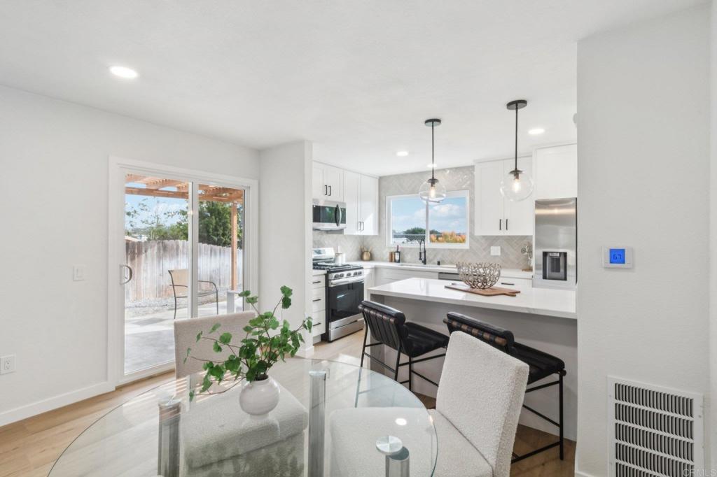 4723 Rim Rock Road Oceanside, CA 92056 - Photo 8 of 29 a kitchen with a table and chairs in it