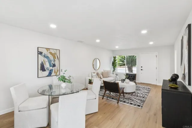 a living room with furniture a rug and a large window