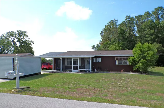 a view of a house with a yard and plants