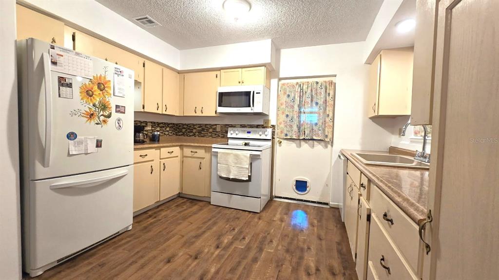 9430 Southwest 102nd Place Ocala, FL 34481 - Photo 12 of 51 a kitchen with white cabinets and white appliances