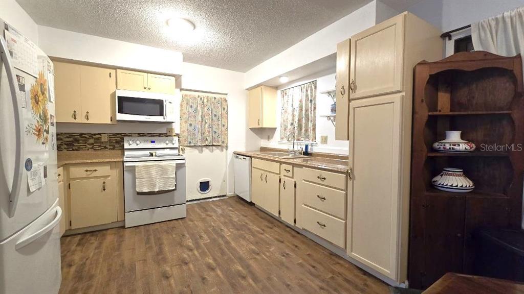 9430 Southwest 102nd Place Ocala, FL 34481 - Photo 15 of 51 a kitchen with white cabinets and white appliances