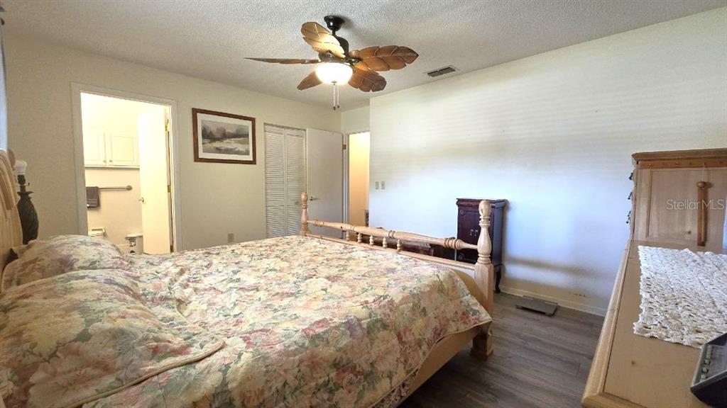 9430 Southwest 102nd Place Ocala, FL 34481 - Photo 22 of 51 a bedroom with a bed and wooden floor