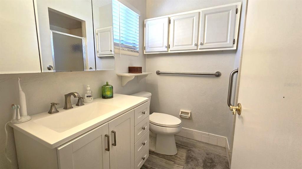 9430 Southwest 102nd Place Ocala, FL 34481 - Photo 24 of 51 a bathroom with a sink a toilet and a mirror