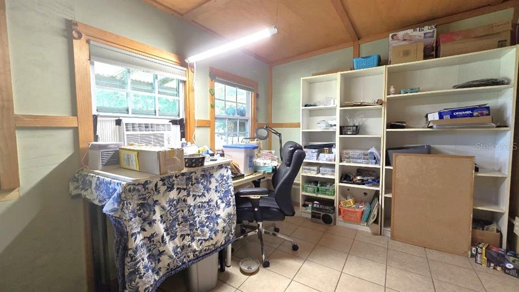 9430 Southwest 102nd Place Ocala, FL 34481 - Photo 27 of 51 a view of a workspace with furniture and a window