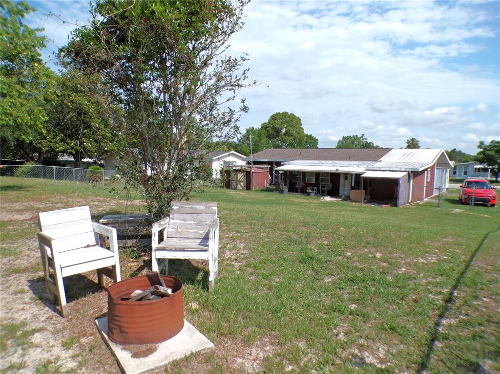 9430 Southwest 102nd Place Ocala, FL 34481 - Photo 35 of 51 a front view of a house with garden and chairs