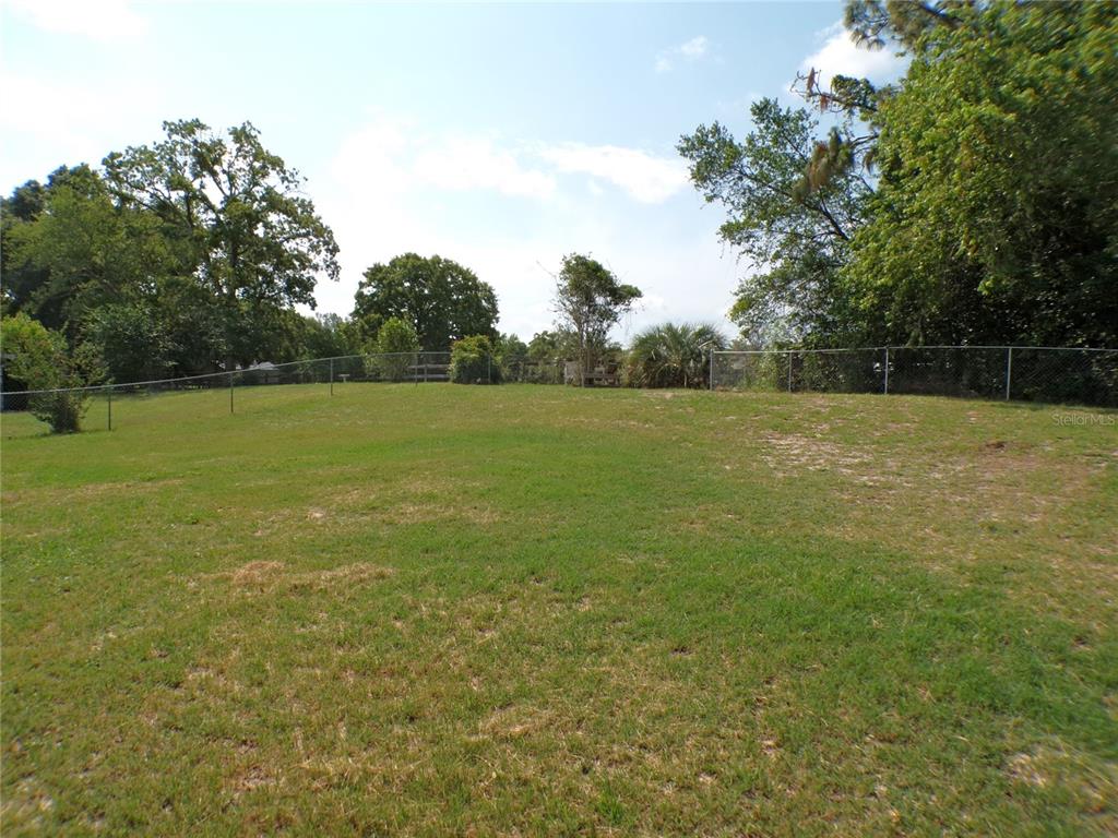 9430 Southwest 102nd Place Ocala, FL 34481 - Photo 38 of 51 a view of a field with an trees in the background