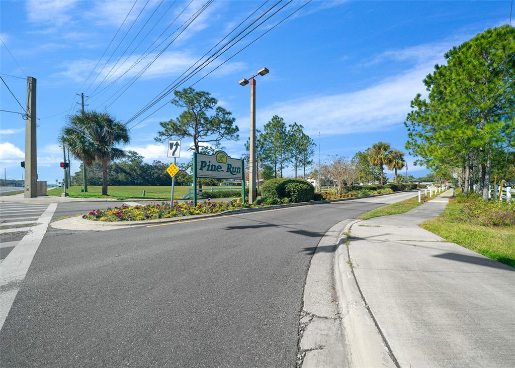 9430 Southwest 102nd Place Ocala, FL 34481 - Photo 41 of 51 a view of a street with a houses in the background