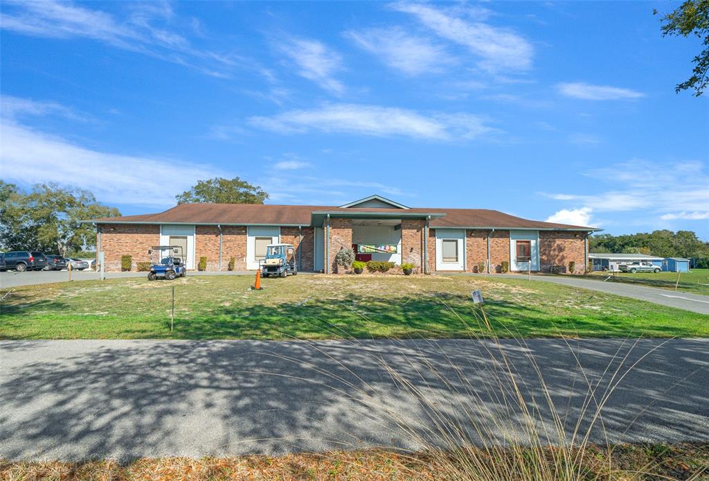 9430 Southwest 102nd Place Ocala, FL 34481 - Photo 46 of 51 a front view of a house with a yard