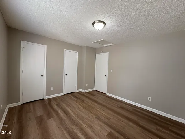 a view of room with wooden floor