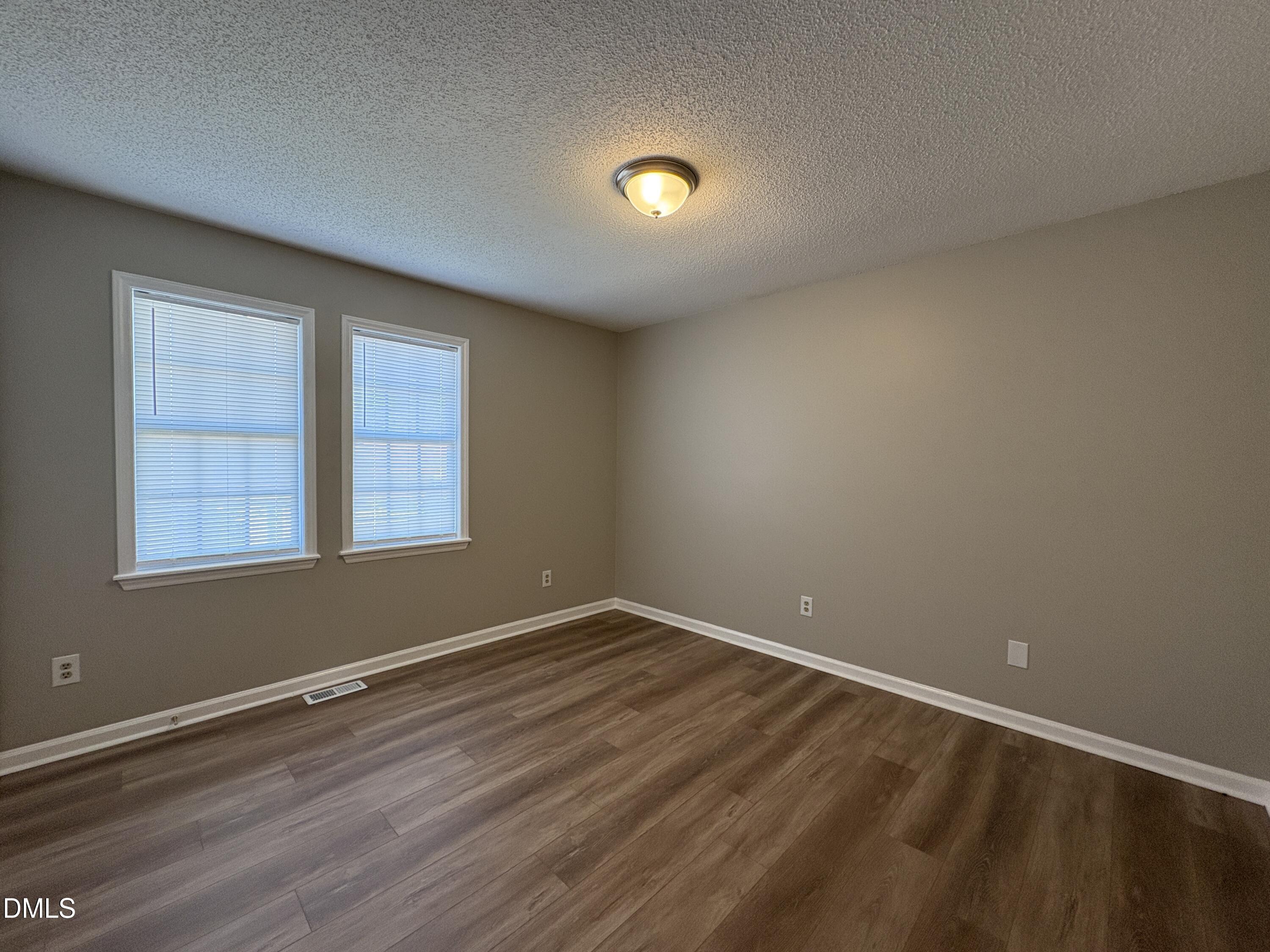 8102 Farmlea Circle Raleigh, NC 27616 - Photo 12 of 16 wooden floor in an empty room with a window