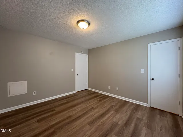 a view of room with wooden floor