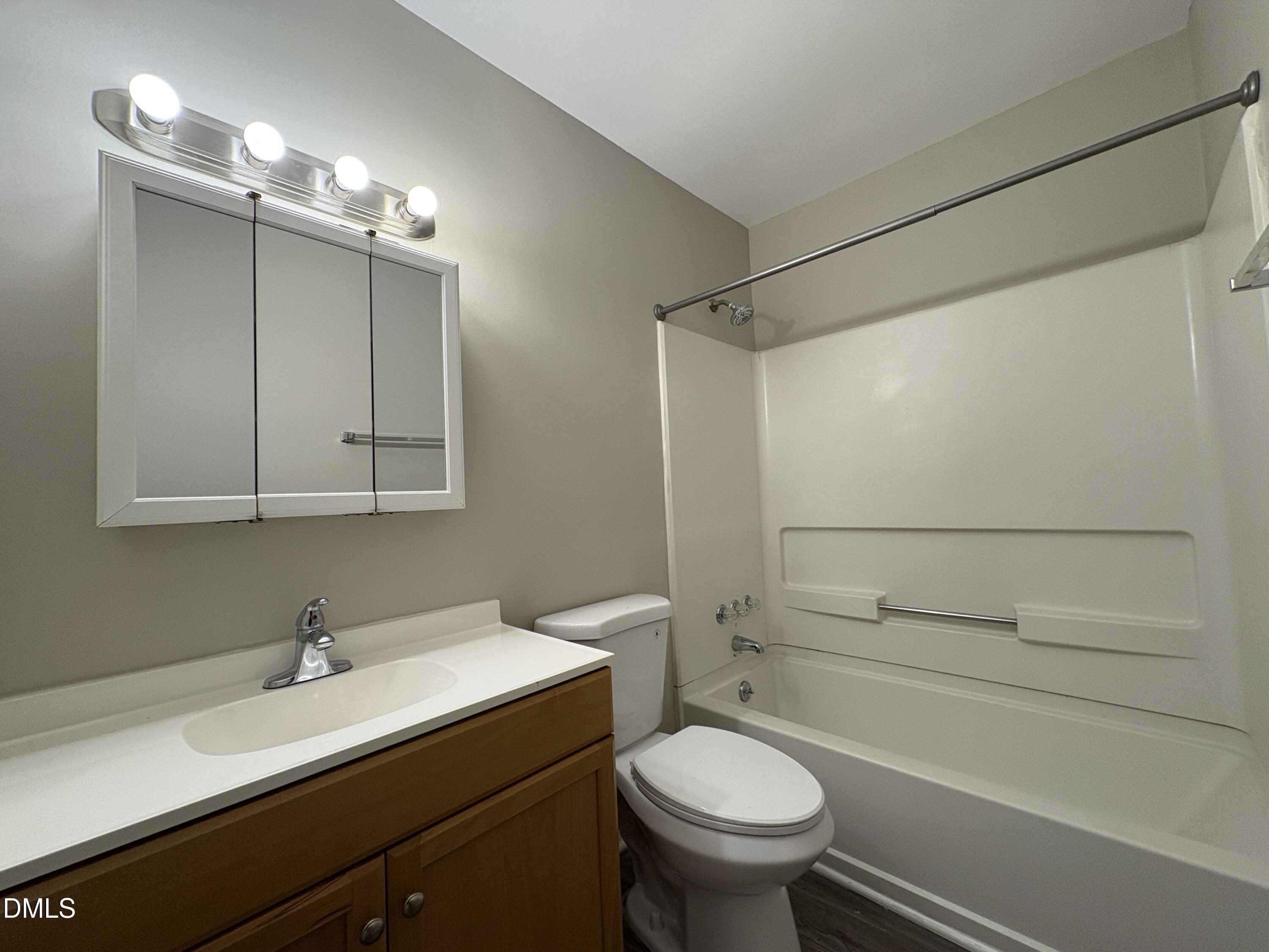 8102 Farmlea Circle Raleigh, NC 27616 - Photo 15 of 16 a bathroom with a sink a toilet and shower