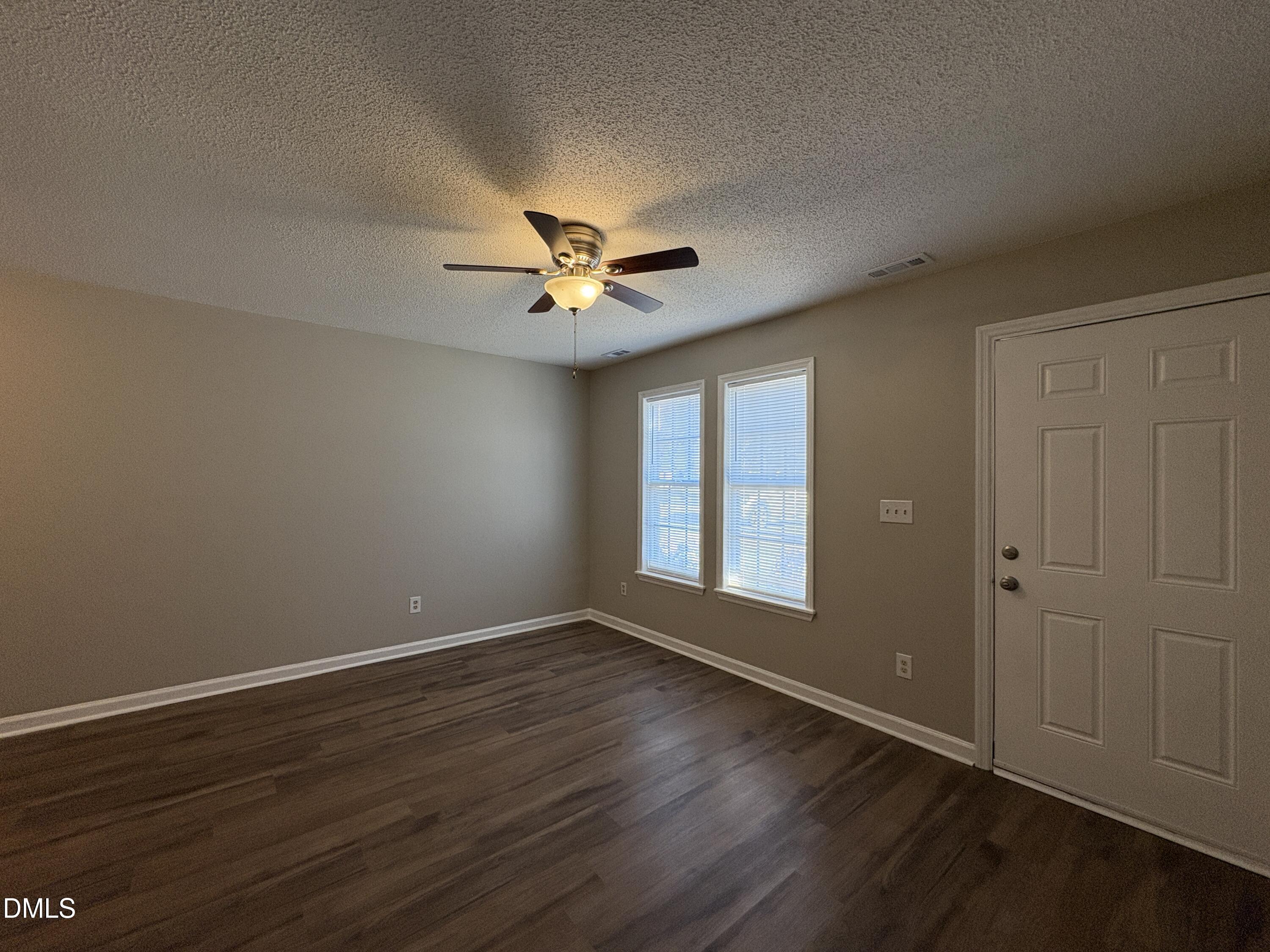 8102 Farmlea Circle Raleigh, NC 27616 - Photo 3 of 16 a view of an empty room with a window and wooden floor