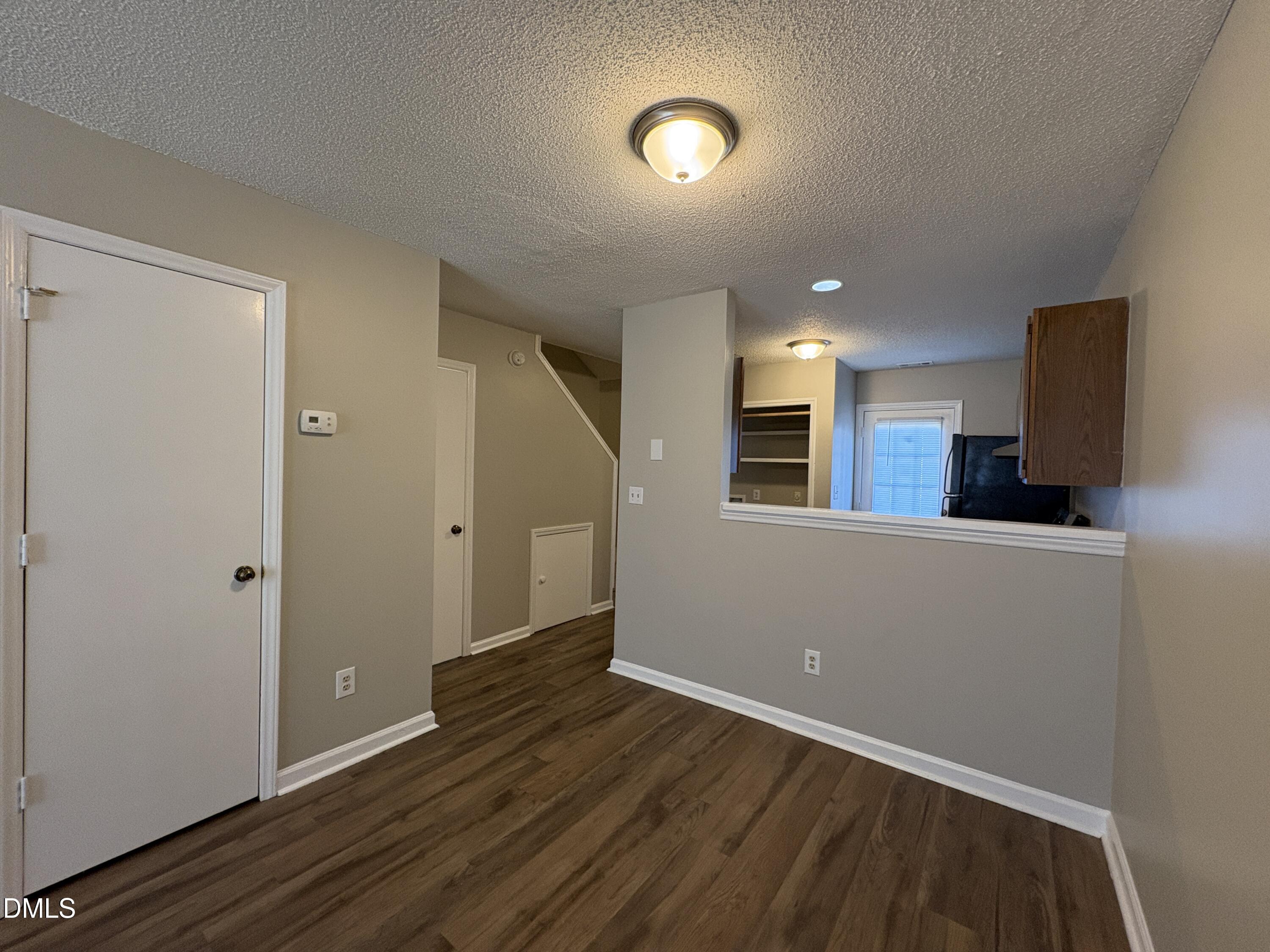 8102 Farmlea Circle Raleigh, NC 27616 - Photo 4 of 16 a view of an empty room with wooden floor and a window