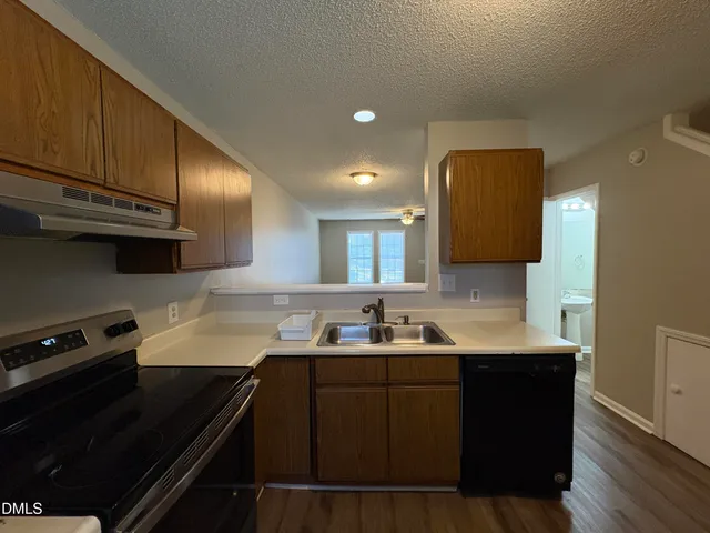 a kitchen with sink and cabinets