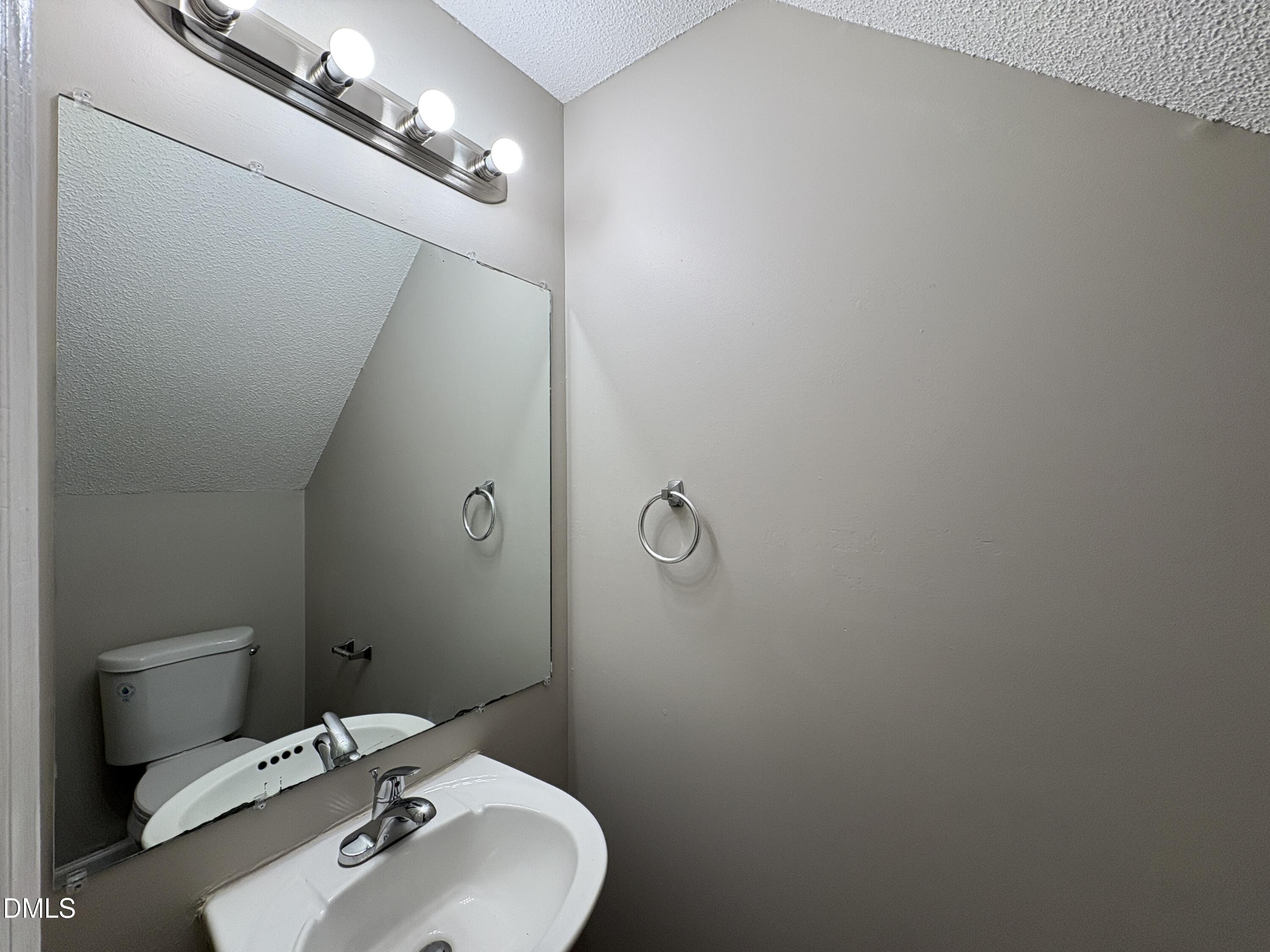 8102 Farmlea Circle Raleigh, NC 27616 - Photo 9 of 16 a bathroom with a sink and mirror