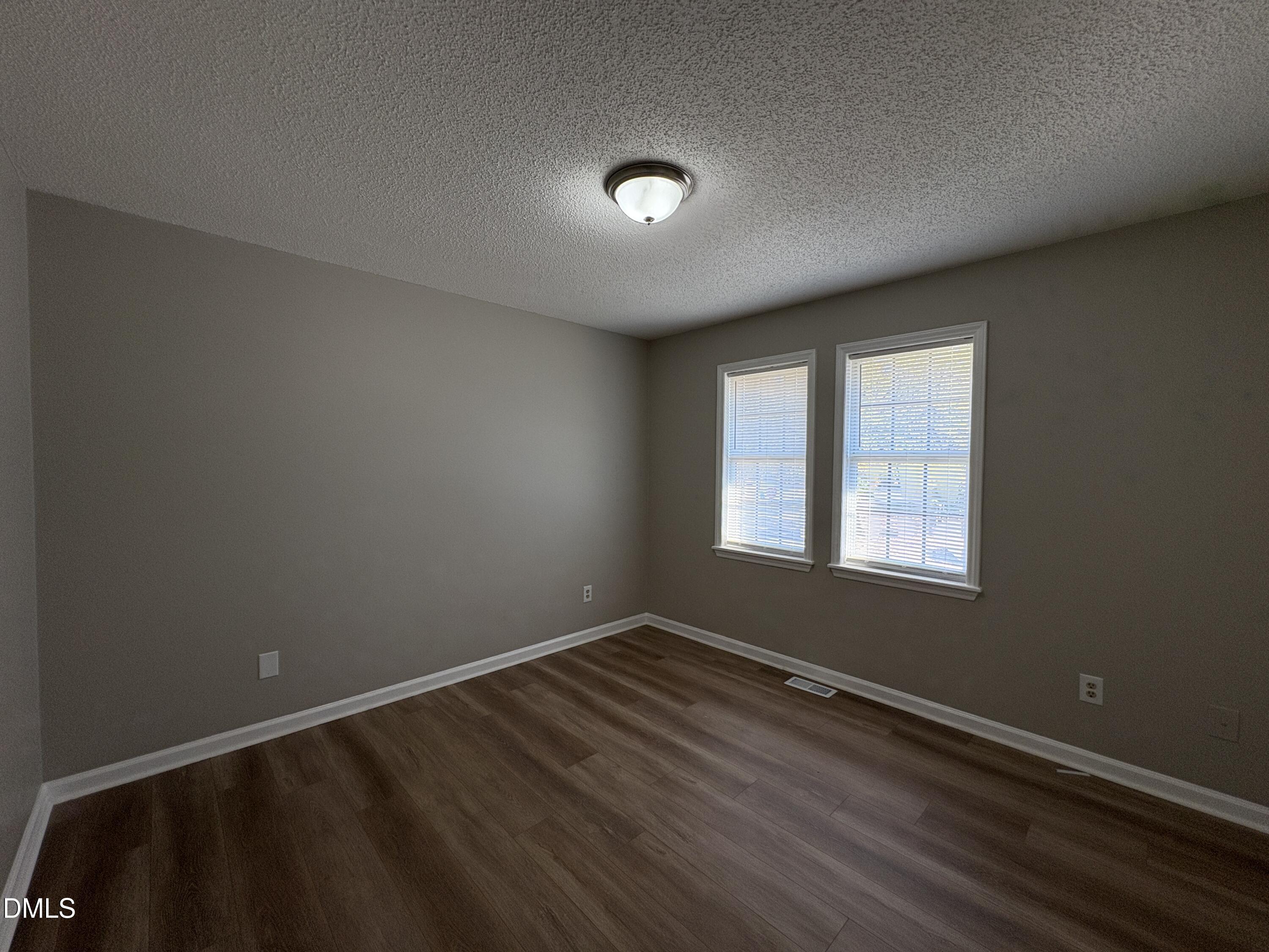 8102 Farmlea Circle Raleigh, NC 27616 - Photo 10 of 16 an empty room with wooden floor and windows