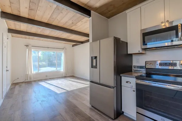 a kitchen with stainless steel appliances a refrigerator stove and microwave