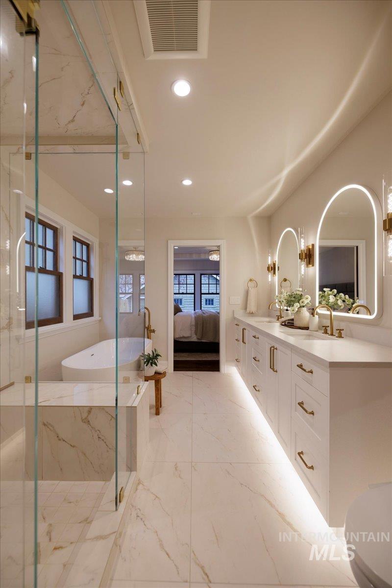 1210 North Harrison Boulevard Boise, ID 83702 - Photo 16 of 39 Ensuite bathroom featuring a freestanding tub, double vanity, recessed lighting, a marble finish shower, and light marble finish flooring