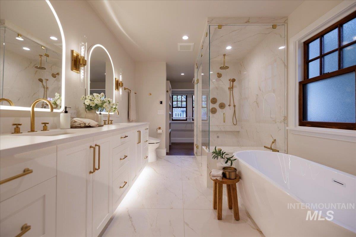 1210 North Harrison Boulevard Boise, ID 83702 - Photo 17 of 39 Bathroom with double vanity, a marble finish shower, a soaking tub, recessed lighting, and light marble finish flooring