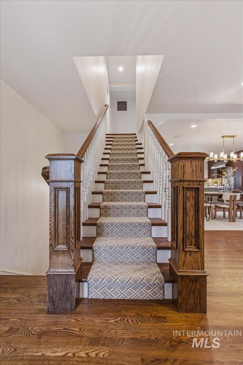1210 North Harrison Boulevard Boise, ID 83702 - Photo 19 of 39 Stairs featuring wood finished floors and hanging lights