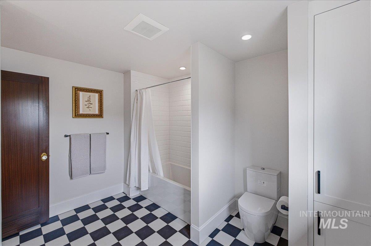 1210 North Harrison Boulevard Boise, ID 83702 - Photo 22 of 39 Full bath featuring light flooring, shower / bath combo with shower curtain, and recessed lighting