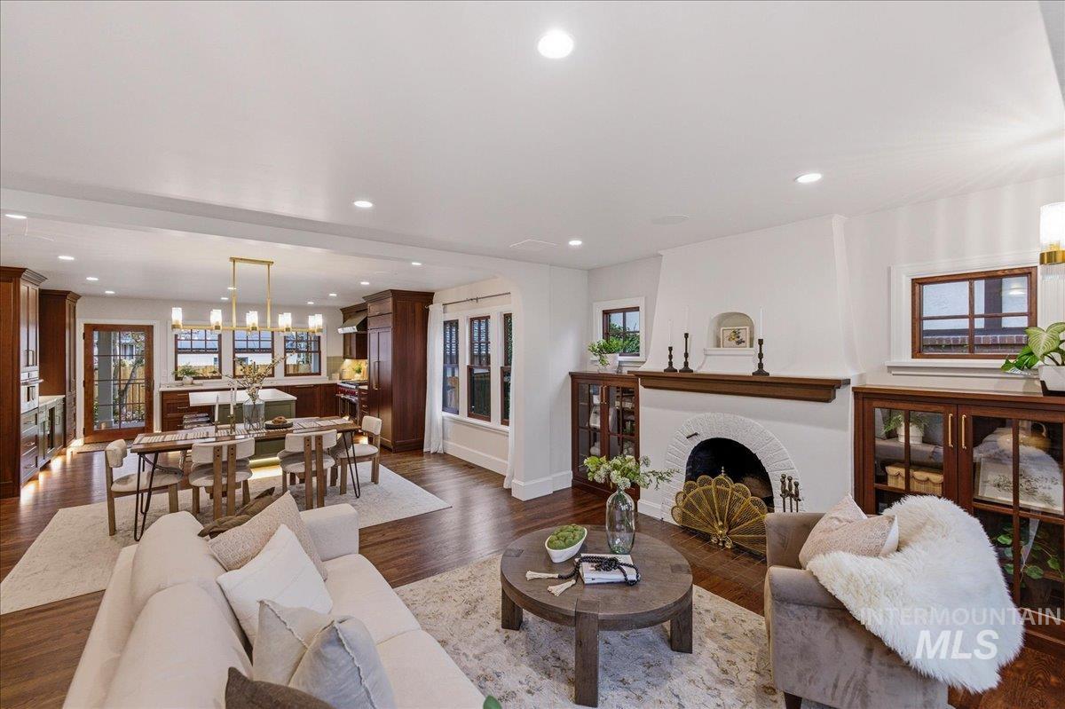 1210 North Harrison Boulevard Boise, ID 83702 - Photo 5 of 39 Living area featuring dark wood finished floors, a fireplace, healthy amount of natural light, and suspended lighting