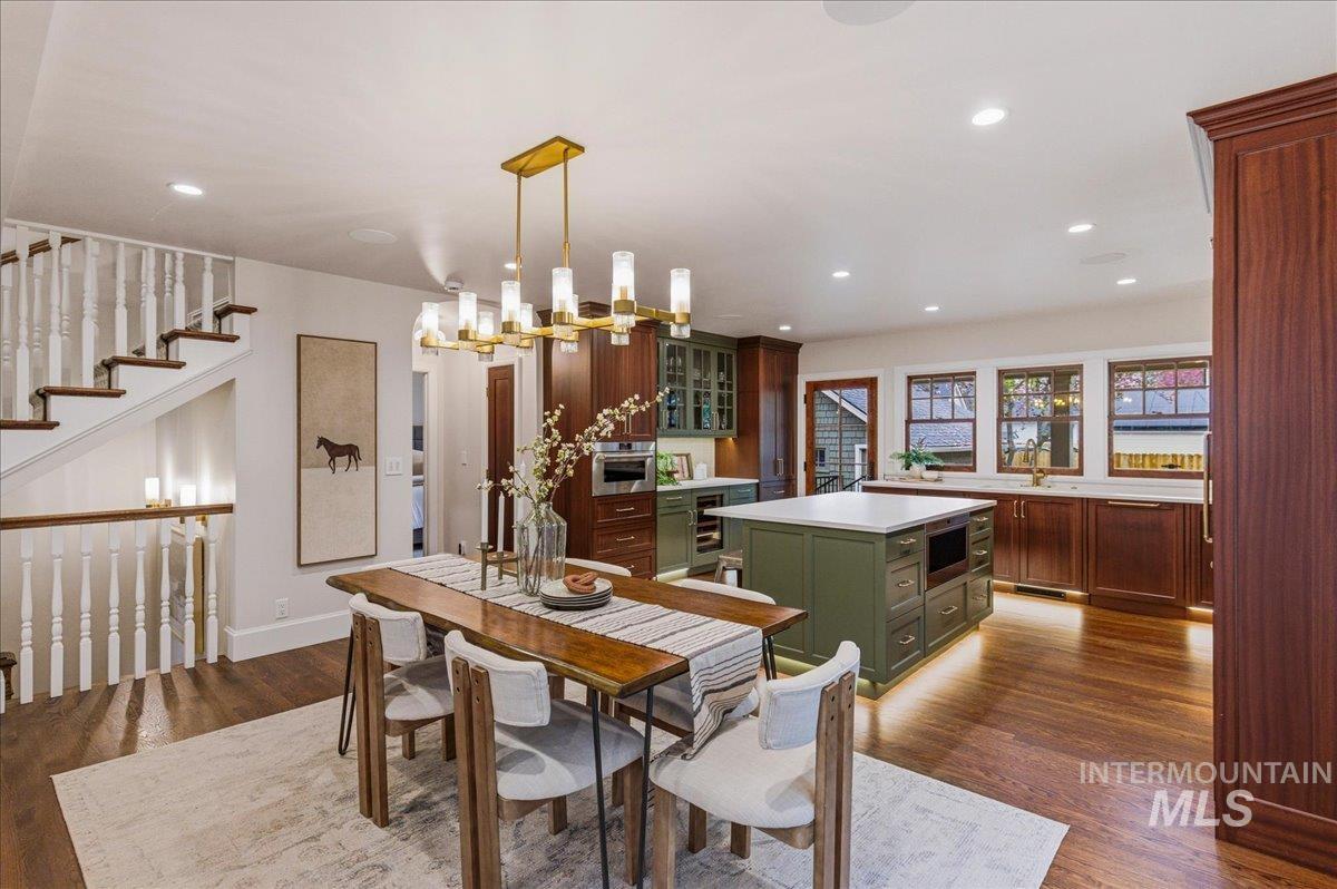 1210 North Harrison Boulevard Boise, ID 83702 - Photo 6 of 39 Dining area featuring dark wood-type flooring, a chandelier, and wine cooler