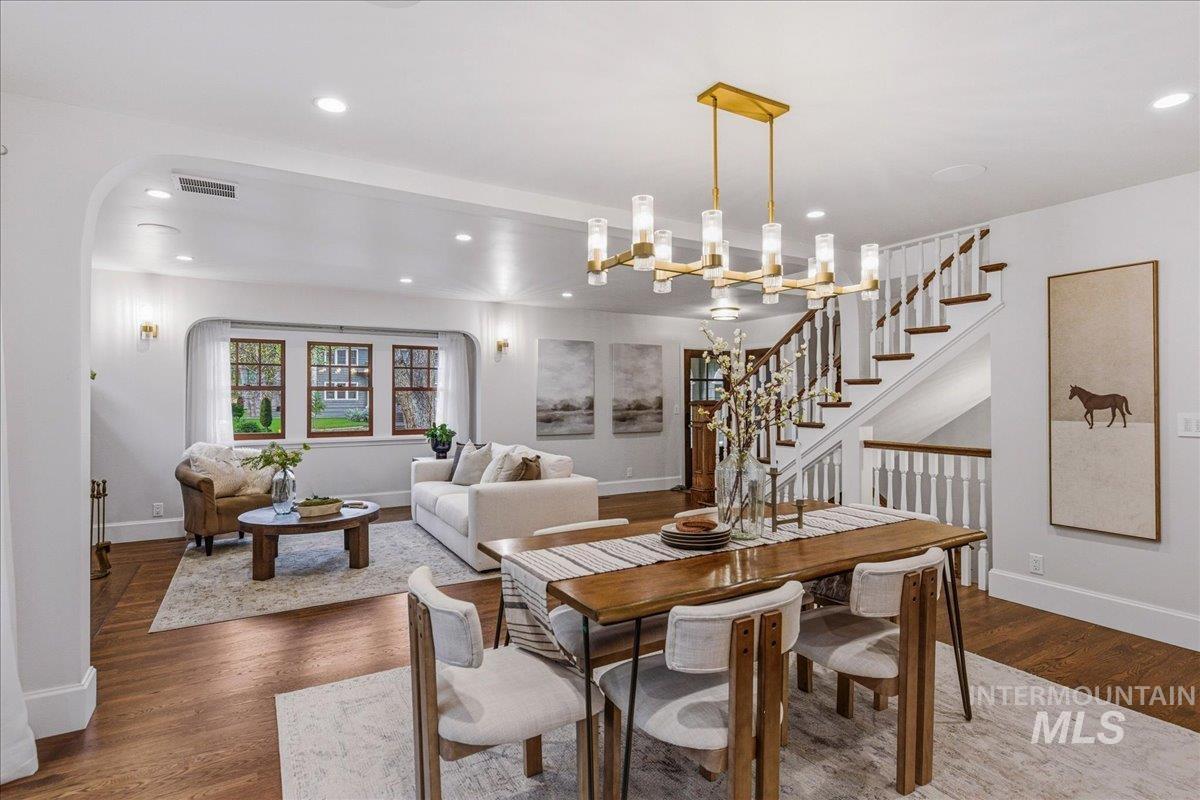 1210 North Harrison Boulevard Boise, ID 83702 - Photo 7 of 39 Dining area featuring dark wood-type flooring, arched walkways, and a chandelier