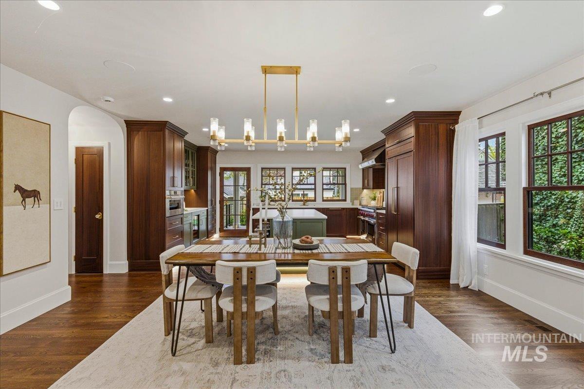 1210 North Harrison Boulevard Boise, ID 83702 - Photo 9 of 39 Dining space with arched walkways, dark wood-style floors, healthy amount of natural light, and recessed lighting