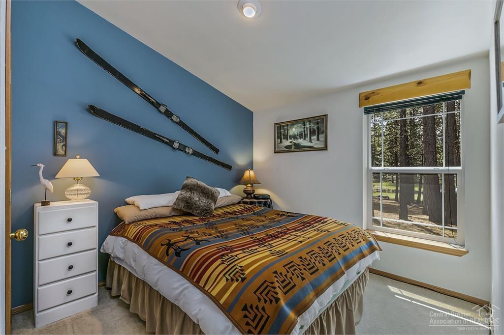 17171 Island Loop Way Bend, OR 97707 - Photo 11 of 25 a bedroom with a large bed and a window