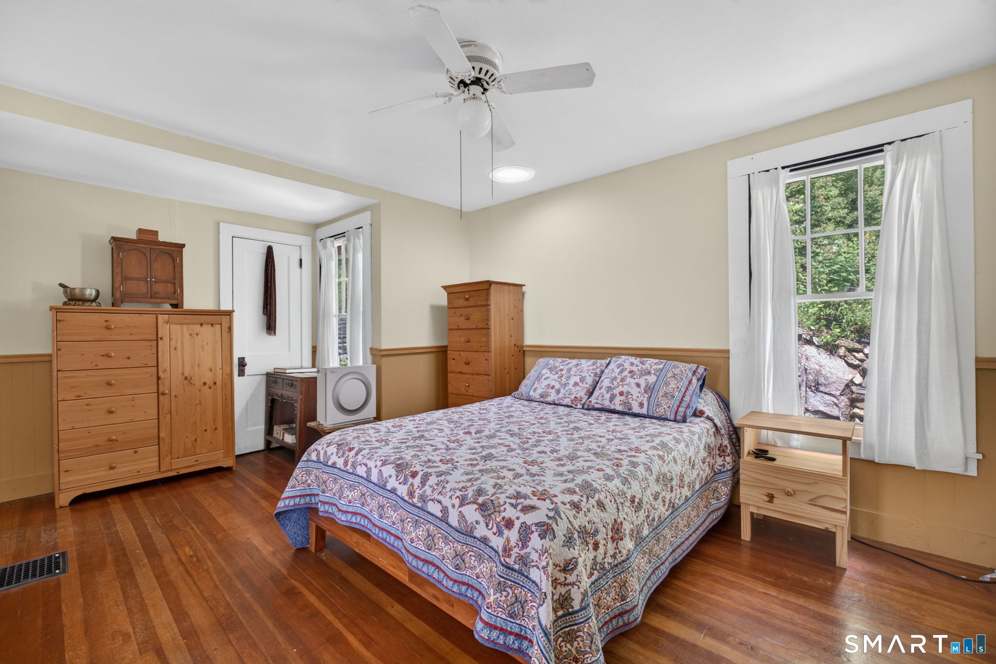 79 River Street Deep River, CT 06417 - Photo 11 of 40 a bedroom with a bed and wooden floor