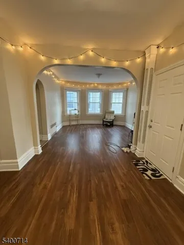 a view of a room with wooden floor and window