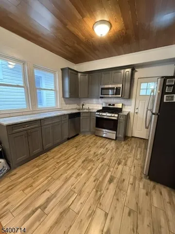 a kitchen with granite countertop a stove top oven and sink