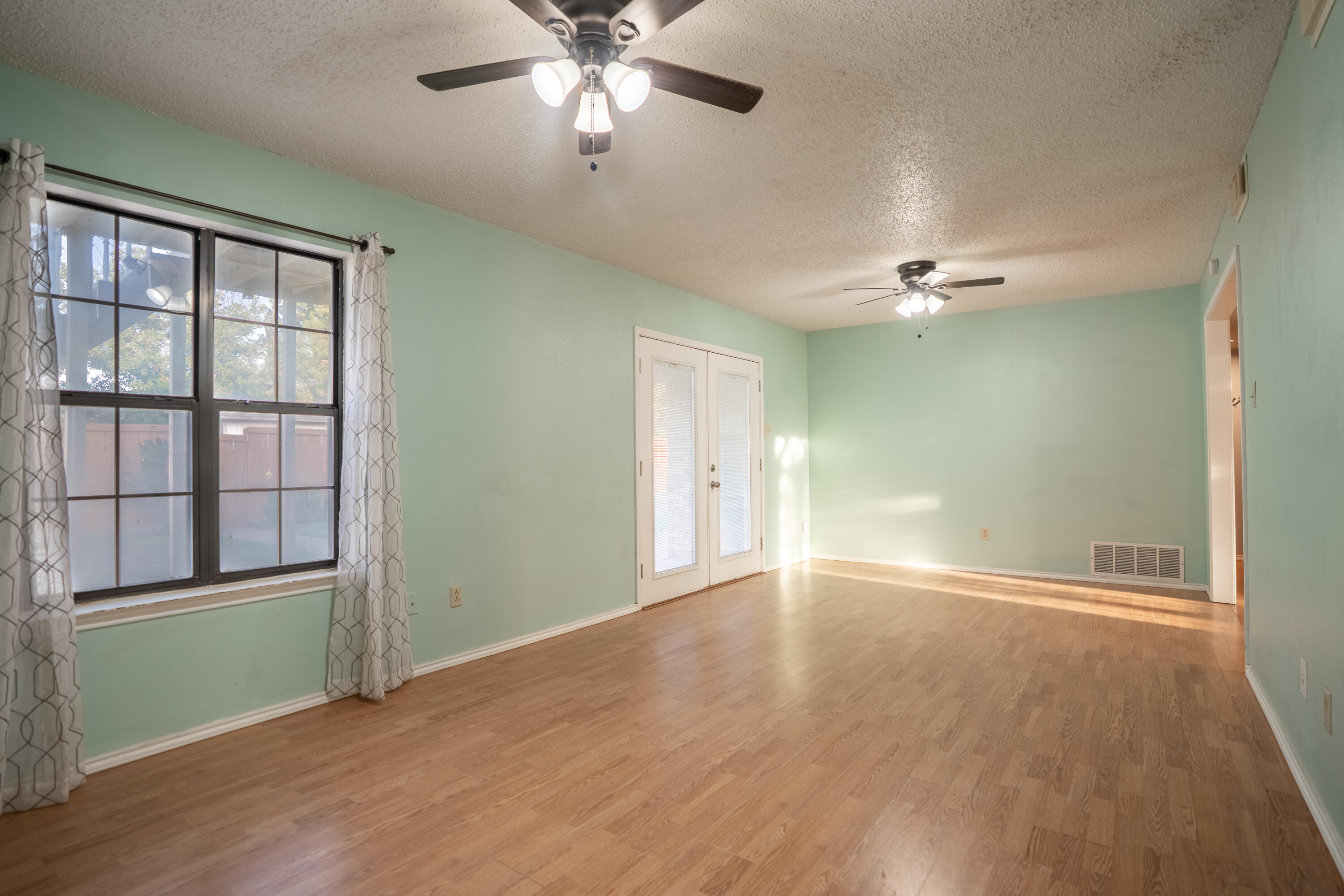 512 North Grover Avenue Lubbock, TX 79416 - Photo 15 of 34 wooden floor in an empty room with a window