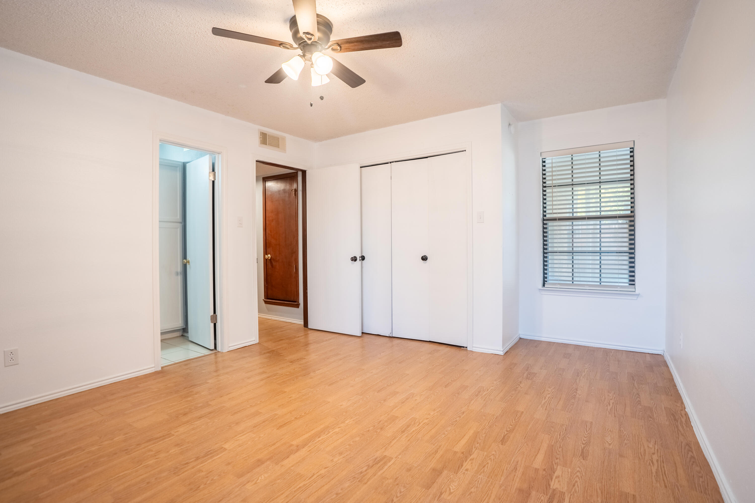 512 North Grover Avenue Lubbock, TX 79416 - Photo 17 of 34 a view of empty room with wooden floor and ceiling fan