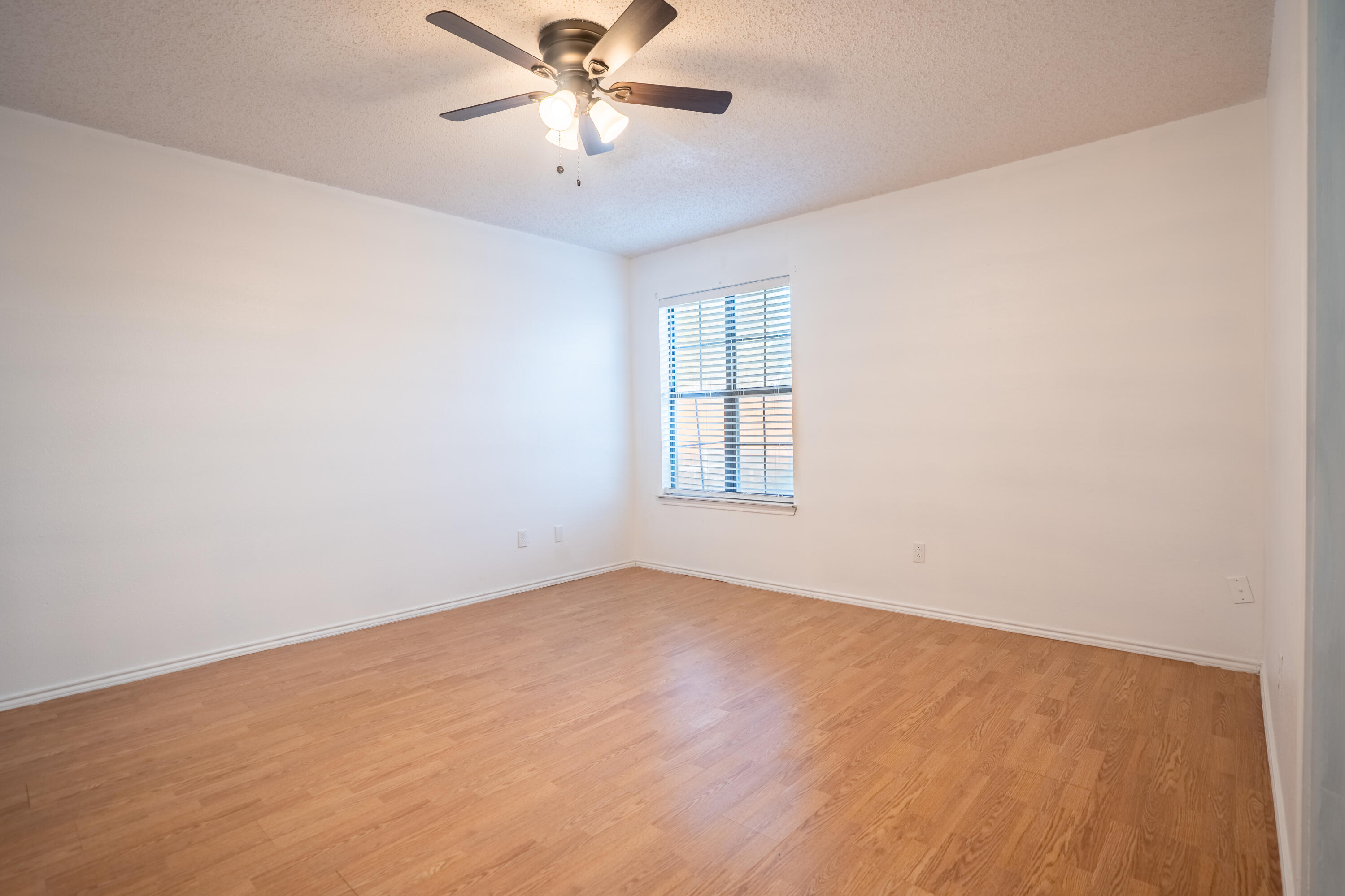 512 North Grover Avenue Lubbock, TX 79416 - Photo 18 of 34 an empty room with windows and fan