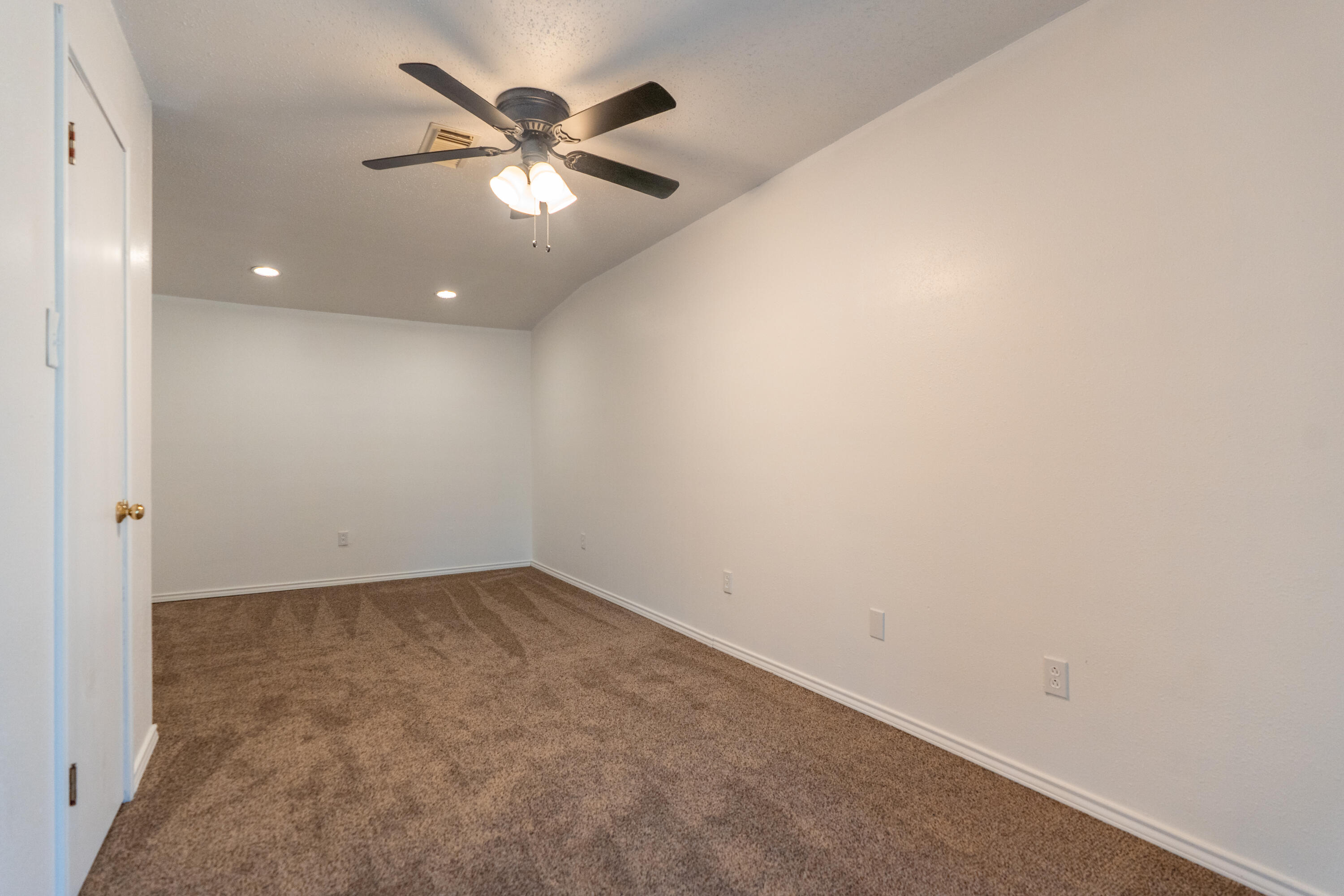 512 North Grover Avenue Lubbock, TX 79416 - Photo 21 of 34 an empty room with a ceiling fan and wooden floor