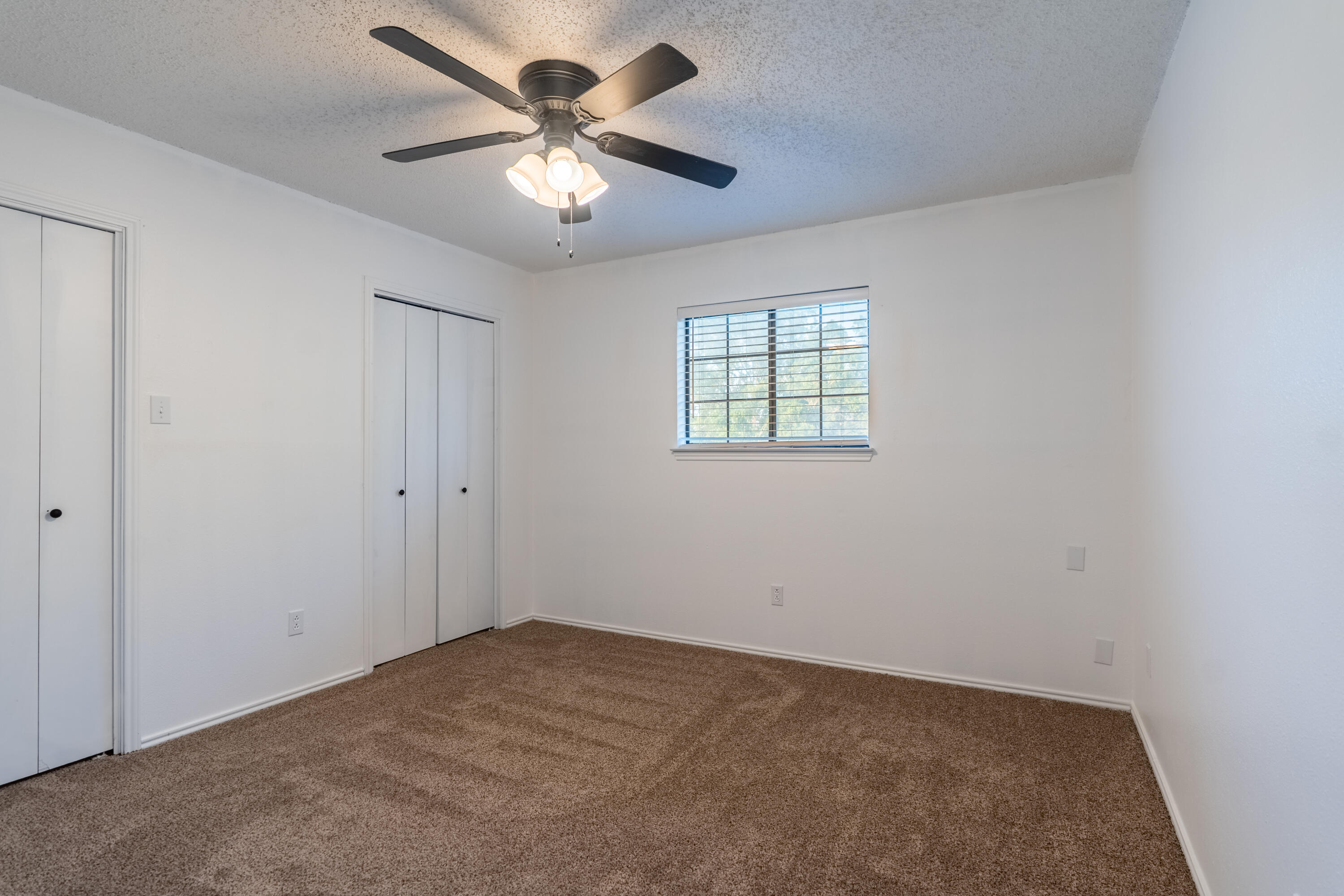 512 North Grover Avenue Lubbock, TX 79416 - Photo 26 of 34 an empty room with windows and fan